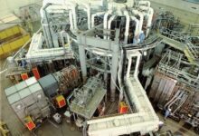 The TFTR tokamak fusion reactor hall with its ring of magnets and pipework